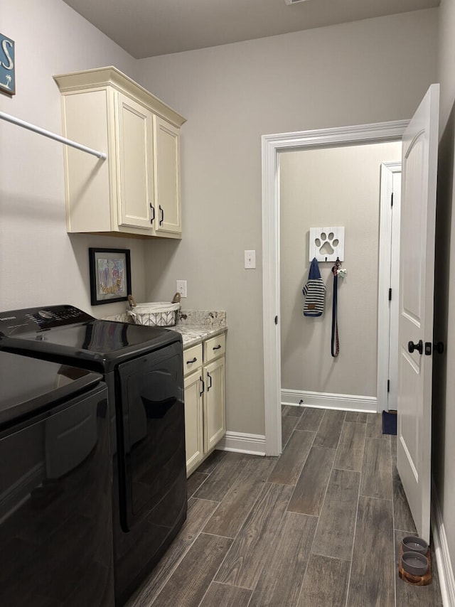 laundry room with washing machine and clothes dryer, wood finish floors, cabinet space, and baseboards