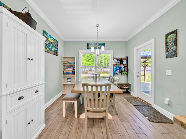 1516 Cadence Lp, Cantonment, FL 32533 - dining space with baseboards, light wood-style floors, a chandelier, and crown molding