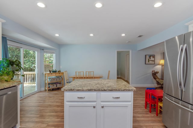 511 Oak Ave, Niceville, FL 32578 - kitchen featuring appliances with stainless steel finishes, light wood-type flooring, white cabinetry, recessed lighting, and light stone countertops