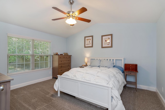 511 Oak Ave, Niceville, FL 32578 - bedroom with lofted ceiling, dark carpet, baseboards, and ceiling fan