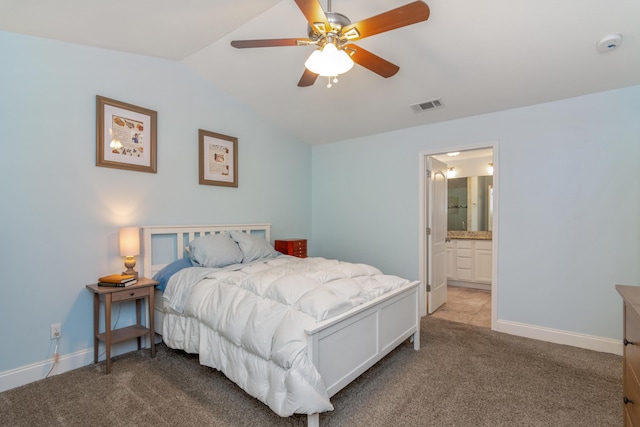 511 Oak Ave, Niceville, FL 32578 - carpeted bedroom with vaulted ceiling, baseboards, a ceiling fan, and ensuite bathroom