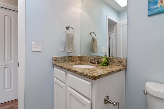 511 Oak Ave, Niceville, FL 32578 - half bath with vanity, toilet, and a skylight