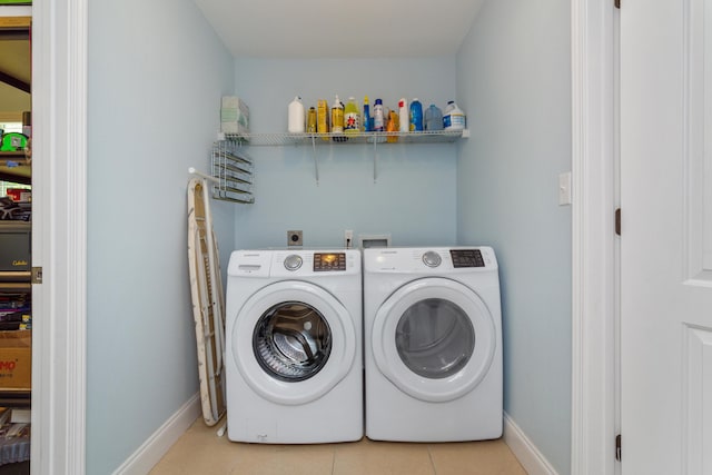 511 Oak Ave, Niceville, FL 32578 - washroom with baseboards, washer and dryer, and tile patterned flooring
