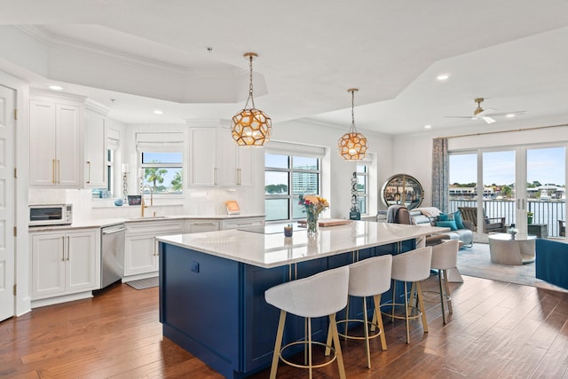 kitchen featuring dark wood-type flooring, recessed lighting, open floor plan, a center island, and stainless steel dishwasher