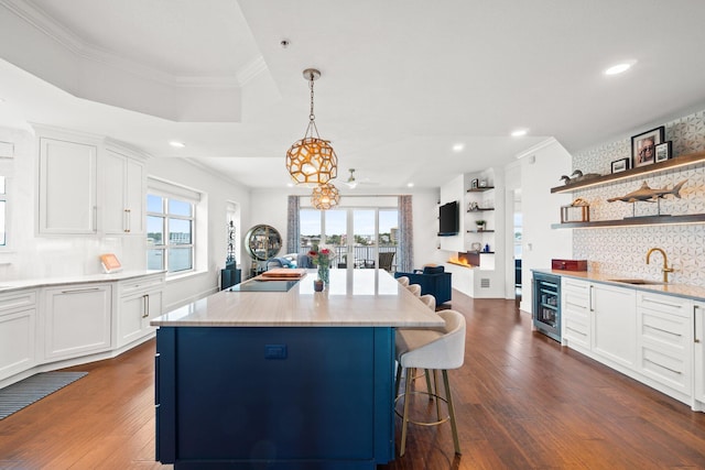 kitchen featuring recessed lighting, dark wood-style floors, wine cooler, and a sink