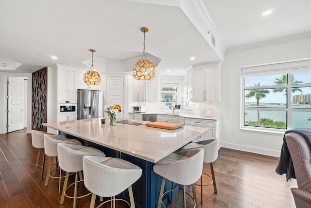 kitchen with stainless steel appliances, dark wood-type flooring, crown molding, white cabinets, and baseboards