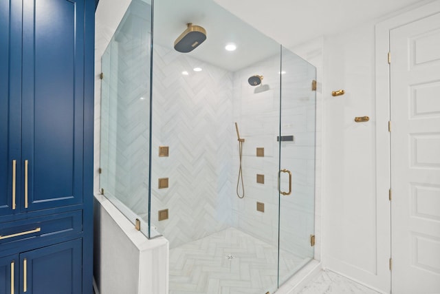 bathroom with a stall shower and marble finish floor