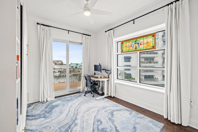 office with baseboards, a ceiling fan, and wood finished floors