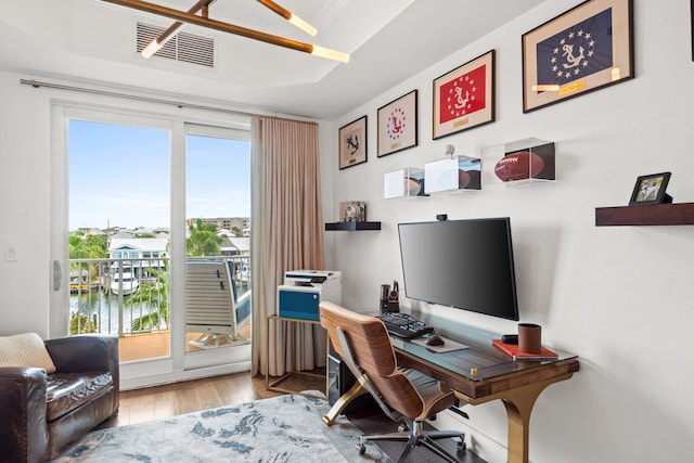 office featuring visible vents and wood finished floors