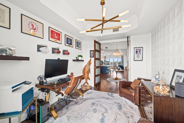office area with a notable chandelier, visible vents, and wood finished floors