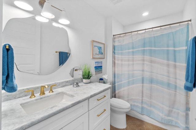 bathroom featuring tile patterned floors, toilet, and vanity