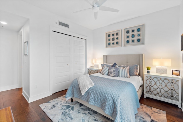 bedroom with a closet, visible vents, baseboards, and hardwood / wood-style floors