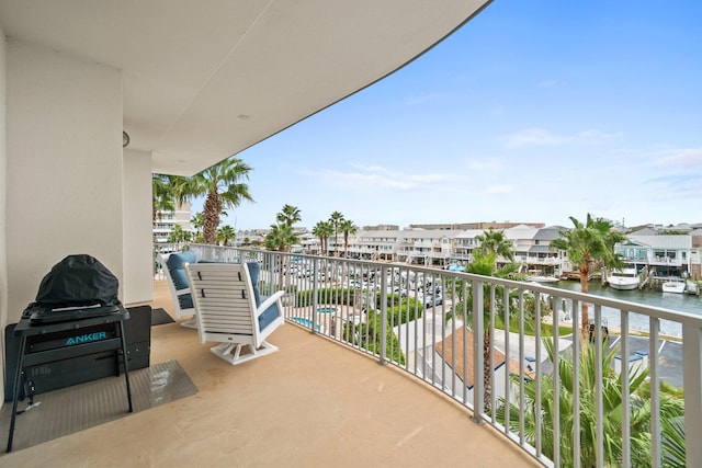 balcony featuring a water view and a residential view