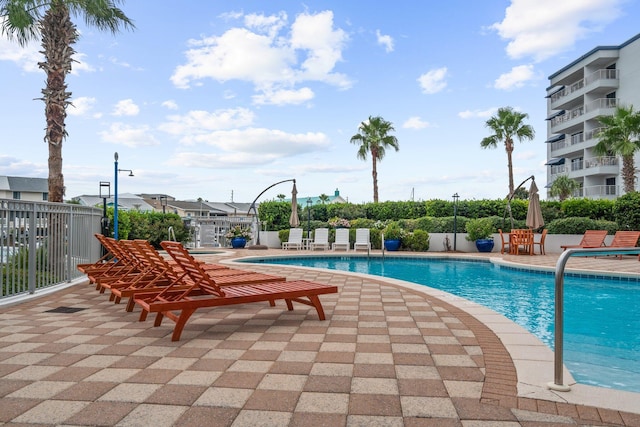 community pool featuring a patio area and fence