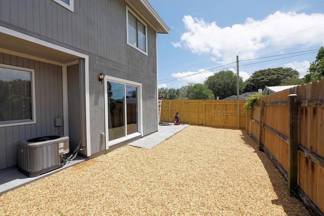 view of yard with cooling unit and a fenced backyard