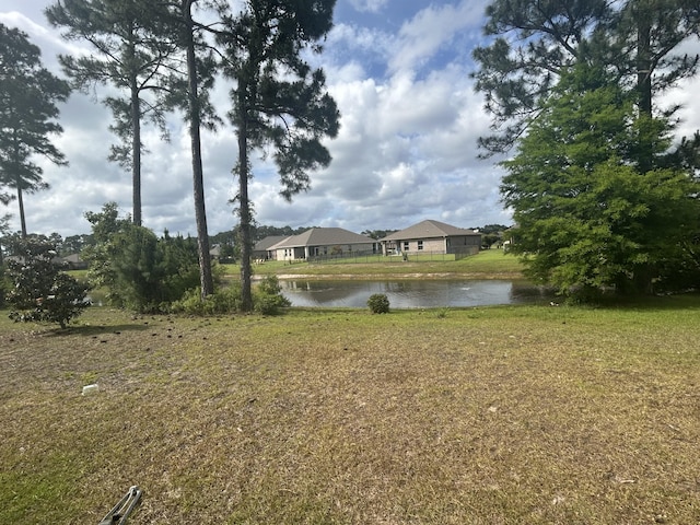 897 Cocobolo Dr, Santa Rosa Beach, FL 32459 - view of grassy yard featuring a water view and a residential view