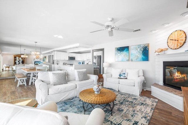 142 Beachside Dr Unit 10, Santa Rosa Beach, FL 32459 - living room featuring wood finished floors, visible vents, baseboards, ceiling fan, and a glass covered fireplace