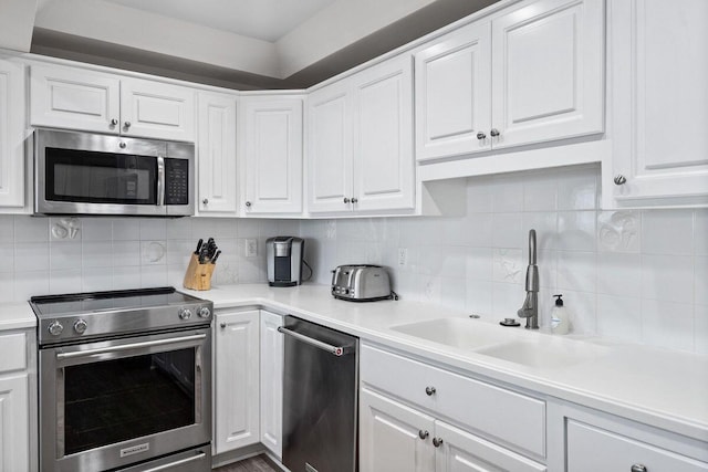142 Beachside Dr Unit 10, Santa Rosa Beach, FL 32459 - kitchen featuring stainless steel appliances, a sink, backsplash, light countertops, and white cabinets