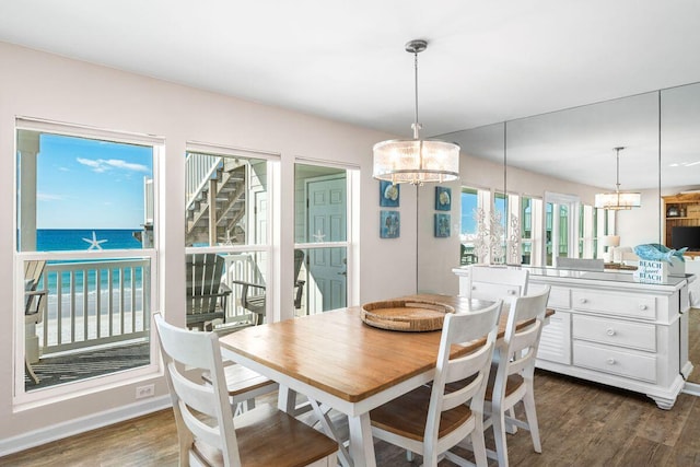 142 Beachside Dr Unit 10, Santa Rosa Beach, FL 32459 - dining area with a water view, a notable chandelier, baseboards, and dark wood-type flooring