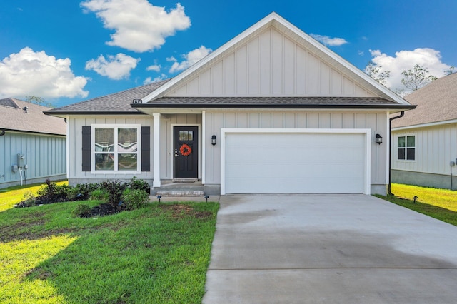 ranch-style home with board and batten siding, concrete driveway, roof with shingles, a front lawn, and an attached garage