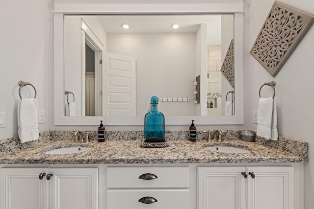 full bathroom featuring a sink, double vanity, and recessed lighting