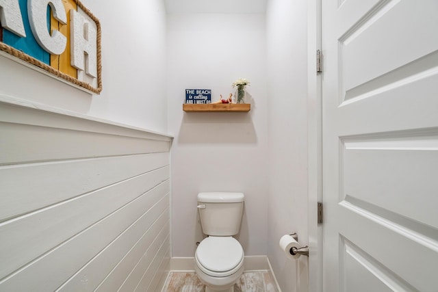 bathroom with toilet and baseboards