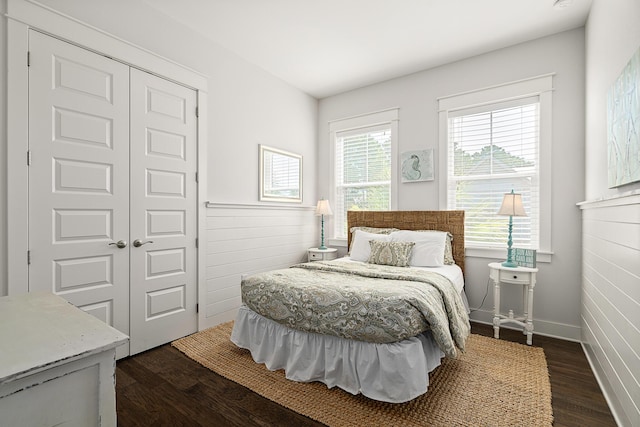bedroom with a closet and dark wood-style flooring