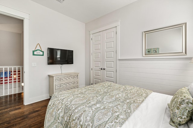 bedroom featuring a closet, baseboards, and wood finished floors