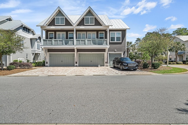 beach home featuring decorative driveway and a garage