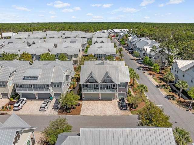 bird's eye view with a wooded view and a residential view