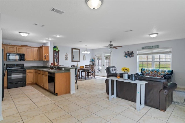 291 Dahlquist Dr, Crestview, FL 32539 - kitchen featuring black appliances, a peninsula, open floor plan, dark countertops, and a kitchen breakfast bar