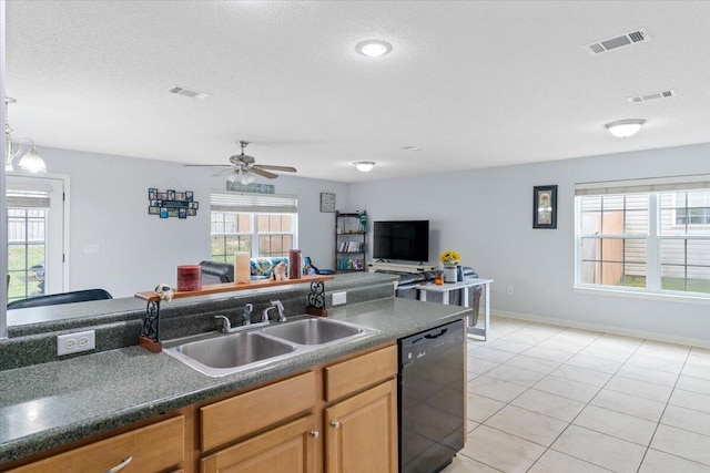 291 Dahlquist Dr, Crestview, FL 32539 - kitchen with dishwasher, a sink, dark countertops, a ceiling fan, and light tile patterned floors