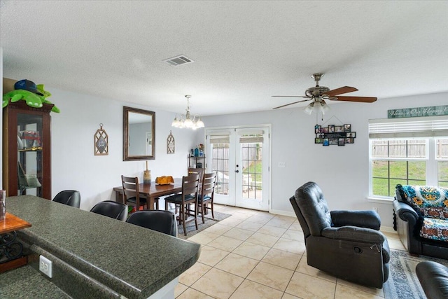 291 Dahlquist Dr, Crestview, FL 32539 - dining area featuring light tile patterned flooring, french doors, a chandelier, and a ceiling fan