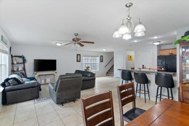 291 Dahlquist Dr, Crestview, FL 32539 - living room with light tile patterned flooring, stairway, ceiling fan, and a chandelier
