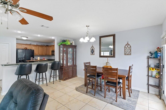 291 Dahlquist Dr, Crestview, FL 32539 - dining room featuring light tile patterned floors, a chandelier, ceiling fan, and baseboards
