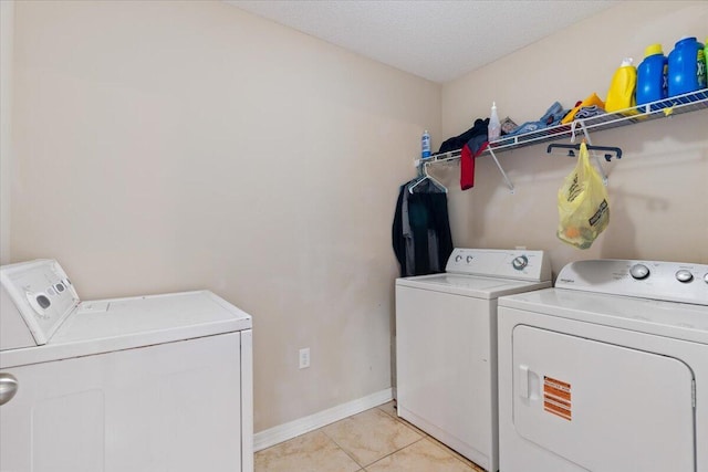 291 Dahlquist Dr, Crestview, FL 32539 - washroom with washing machine and clothes dryer, light tile patterned floors, baseboards, and a textured ceiling