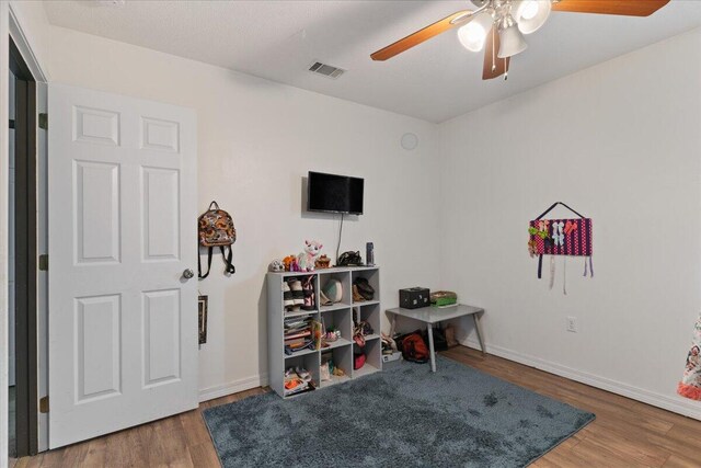 291 Dahlquist Dr, Crestview, FL 32539 - game room featuring a ceiling fan, wood finished floors, and baseboards