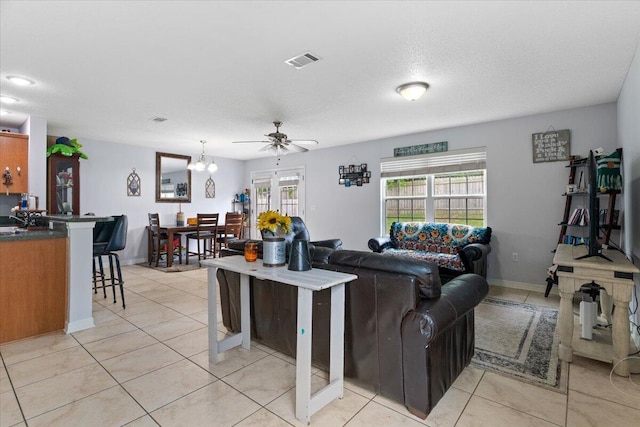 291 Dahlquist Dr, Crestview, FL 32539 - living room with light tile patterned floors, ceiling fan, and baseboards
