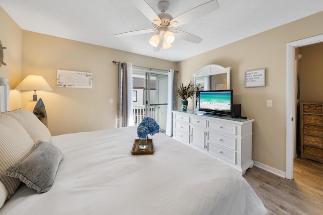 bedroom featuring ceiling fan, access to outside, baseboards, and wood finished floors