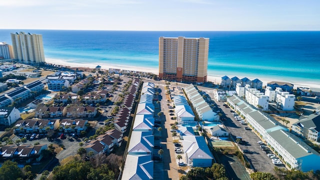 bird's eye view with a water view and a beach view