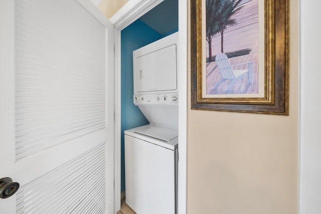 laundry room featuring stacked washer / dryer and laundry area