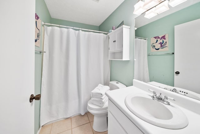 bathroom with tile patterned floors, toilet, and vanity
