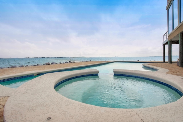 outdoor pool featuring a water view