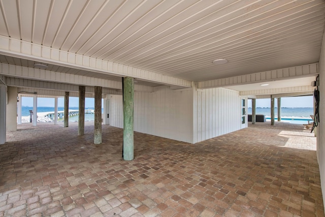 view of patio / terrace featuring view of water and beach