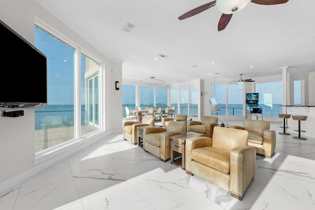 living room with a ceiling fan, marble finish floors, plenty of natural light, ornamental molding, and recessed lighting
