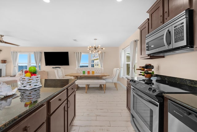 kitchen featuring appliances with stainless steel finishes, open floor plan, a chandelier, plenty of natural light, and recessed lighting