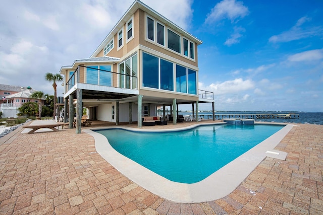 view of pool featuring a patio area, a pool with connected hot tub, and an outdoor hangout area