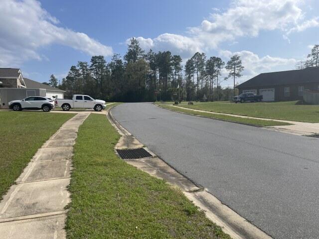 view of road with curbs and sidewalks