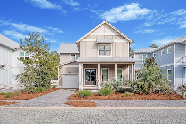 257 Matts Way, Santa Rosa Beach, FL 32459 - craftsman house featuring board and batten siding, a standing seam roof, decorative driveway, covered porch, and an attached garage