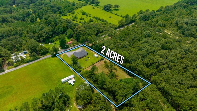 birds eye view of property with a wooded view